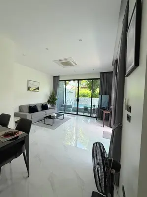 a living room with a couch and a table at Вилла 2 санузла, 2 спальни in Ban Suan