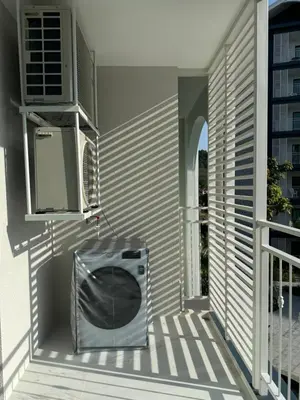 a balcony with a television sitting on a porch at The Title Halo1 2BD by MILL in Phuket