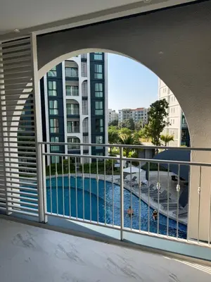 a balcony with a view of a swimming pool at The Title Halo1 2BD by MILL in Phuket