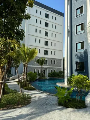 a building with a swimming pool in front of a building at The Title Halo1 2BD by MILL in Phuket