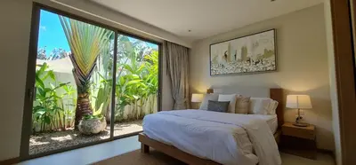 a bedroom with a bed and a large window at Luxury 3 bedroom pool villa in Laguna Phuket