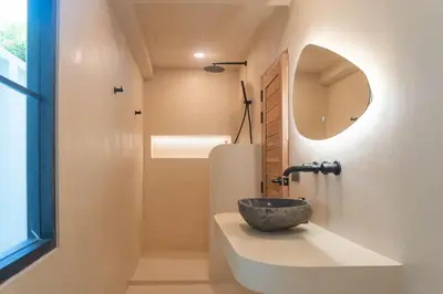 a bathroom with a bowl sink and a mirror at Villa Cabana in Ban Saiyuan (1)