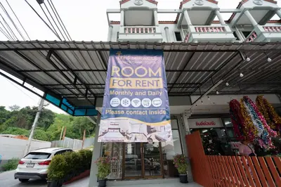 a room for rent sign in front of a store at Tri's Miracle Apartment Kata in Kata Beach