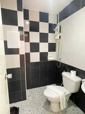 a bathroom with a toilet and a shower at SHERRY'S Guest House in Patong Beach