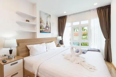 a bedroom with a swan decoration on a bed at Calypso condo in Rawai Beach