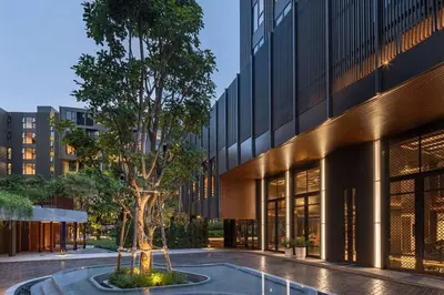 a tree in a courtyard in front of a building at The Base Central Phuket-C4YW in Phuket Town