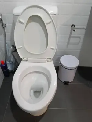 a white toilet with the lid up in a bathroom at The Base Central Phuket-C4YW in Phuket Town
