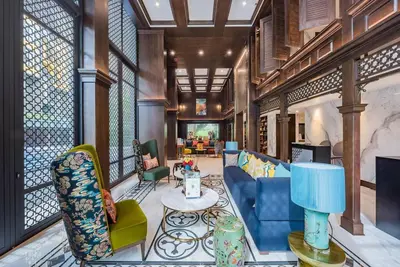 a living room with a blue couch and chairs at The Base Central Phuket-C4YW in Phuket Town