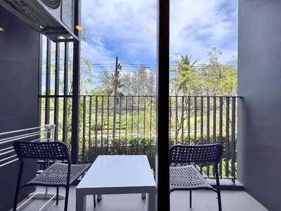 a table and chairs on a balcony with a view at Skypark private new apartmant in Phuket