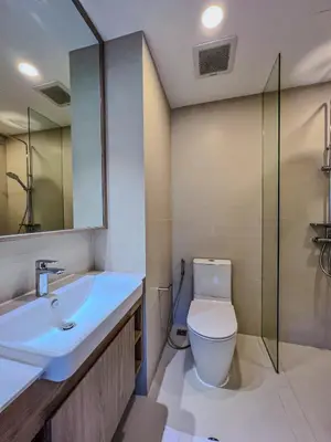 a bathroom with a toilet and a sink and a mirror at Skypark private new apartmant in Phuket