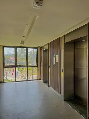 an empty hallway in a building with a large window at Skypark private new apartmant in Phuket