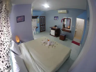 a bedroom with a large bed with a mirror at Adams house in Patong Beach