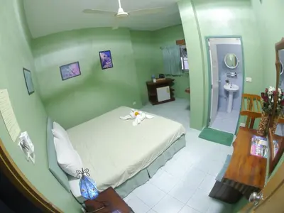 a bedroom with a white bed and a bathroom at Adams house in Patong Beach