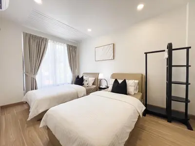 a hotel room with two beds and a window at 4BR Patong Pool Villa, Sleeps 8 in Patong Beach