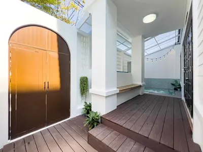 a hallway with a large door and a wooden deck at 4BR Patong Pool Villa, Sleeps 8 in Patong Beach