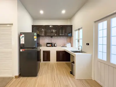 a kitchen with a black refrigerator and a sink at 4BR Patong Pool Villa, Sleeps 8 in Patong Beach
