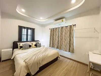 a bedroom with a bed and a window at 4BR Patong Pool Villa, Sleeps 8 in Patong Beach