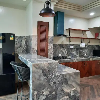 a kitchen with a marble counter and a sink at Naiharn high view villa in Rawai Beach