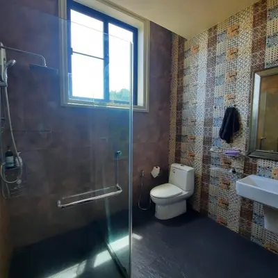 a bathroom with a shower and a toilet and a window at Naiharn high view villa in Rawai Beach