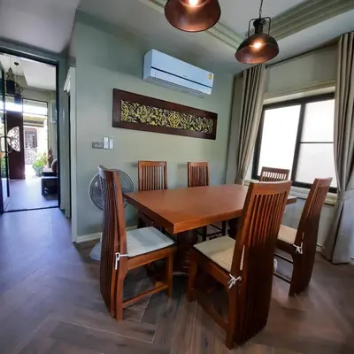 a dining room with a wooden table and chairs at Naiharn high view villa in Rawai Beach