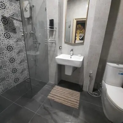 a bathroom with a sink and a shower and a toilet at Naiharn high view villa in Rawai Beach