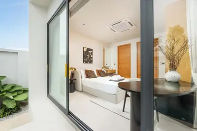 a living room with a table and a couch at Luxury 3BR Villa Eden with Private Pool in Bang Tao Beach