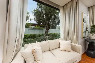 a white couch in a living room with a window at Luxury 3BR Villa Eden with Private Pool in Bang Tao Beach