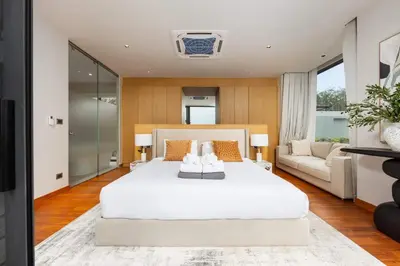 a bedroom with a large white bed and a couch at Luxury 3BR Villa Eden with Private Pool in Bang Tao Beach