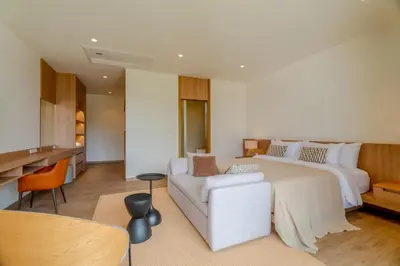 a large bedroom with a white bed and a couch at Sava Villa near Rawai in Ban Saiyuan (1)