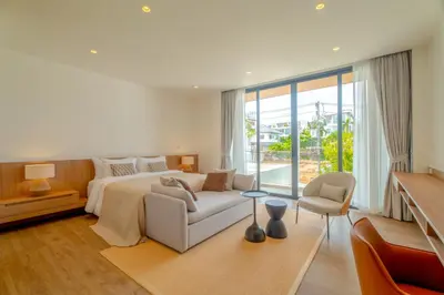 a bedroom with a bed and a couch and a chair at Sava Villa near Rawai in Ban Saiyuan (1)