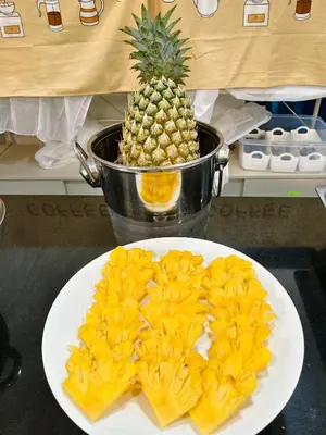 a plate of food with a pineapple on a counter at The Answer Hotel in Ao Nang Beach