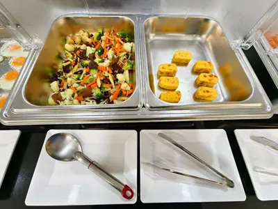 two trays of food on white plates on a table at The Answer Hotel in Ao Nang Beach