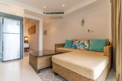 a living room with a couch and a glass table at Apartment Kata Ocean View in Kata Beach