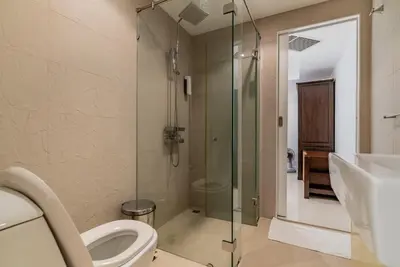 a bathroom with a toilet and a glass shower at Apartment Kata Ocean View in Kata Beach
