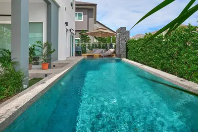 a swimming pool in the backyard of a house at Phuket Paradise Retreat in Phuket Town