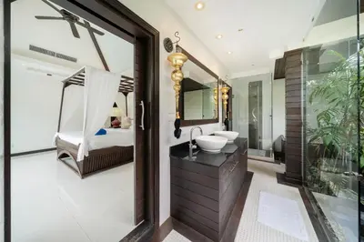 a bathroom with a sink and a bed and a mirror at Laguna luxury pool villa 3 bedroom in Phuket