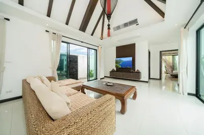 a living room with a couch and a table at Laguna luxury pool villa 3 bedroom in Phuket