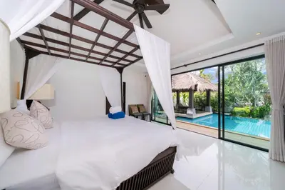 a bedroom with a bed and a swimming pool at Laguna luxury pool villa 3 bedroom in Phuket