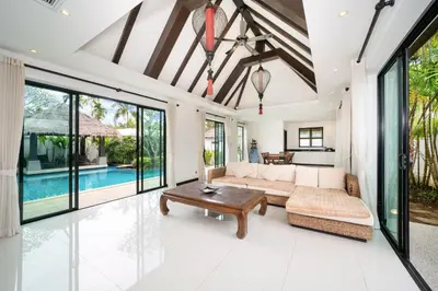 an open living room with a couch and a table at Laguna luxury pool villa 3 bedroom in Phuket