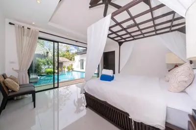 a bedroom with a large bed and a pool at Laguna luxury pool villa 3 bedroom in Phuket