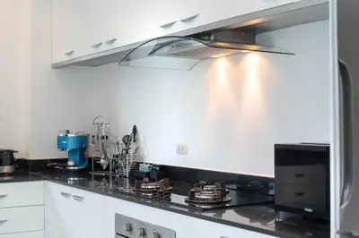 a kitchen with a black stove top oven at Laguna luxury pool villa 3 bedroom in Phuket
