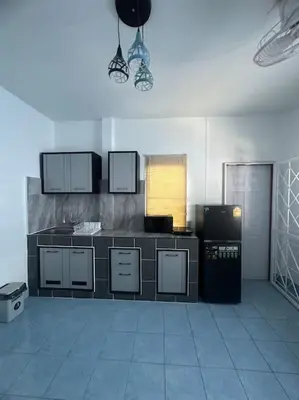 a kitchen with a counter and appliances in a room at P&I Group Home 4 Karon beach in Karon Beach