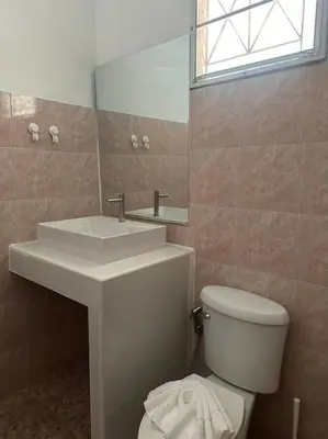a bathroom with a sink and a toilet and a mirror at P&I Group Home 4 Karon beach in Karon Beach