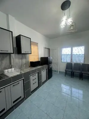 a kitchen with a counter and chairs in a room at P&I Group Home 4 Karon beach in Karon Beach
