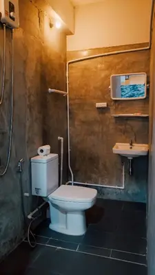 a bathroom with a toilet and a sink at P&I Group Nana apartments 2&3 in Karon Beach
