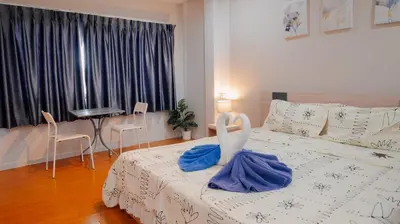 a bedroom with a bed with a swan on it at P&I Group Nana apartments 2&3 in Karon Beach
