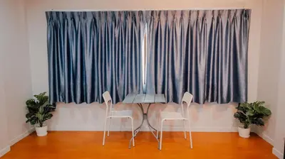 a table and two chairs in front of a window at P&I Group Nana apartments 2&3 in Karon Beach