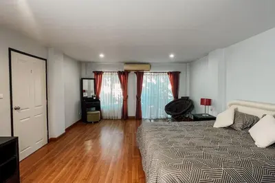 a bedroom with a bed and a wooden floor at Rawai Palm Beach Квартира 220м in Rawai Beach