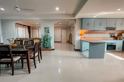 a kitchen and dining room with a table and chairs at Rawai Palm Beach Квартира 220м in Rawai Beach