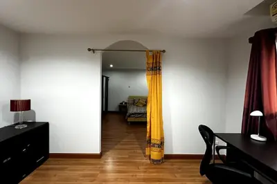 a living room with a bed and a yellow curtain at Rawai Palm Beach Квартира 220м in Rawai Beach